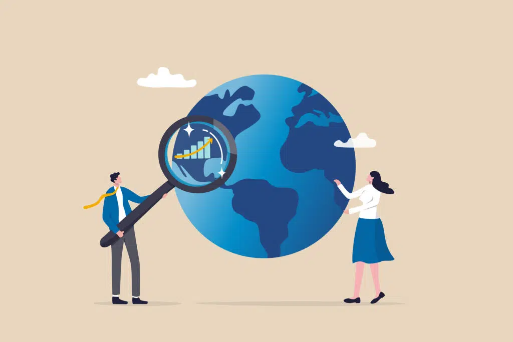 2 people looking at the world and various global financial indices